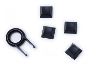 4 Keyzen keycaps in black with the puller