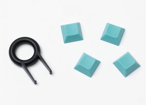 4 Keyzen keycaps in mint color with the cap puller
